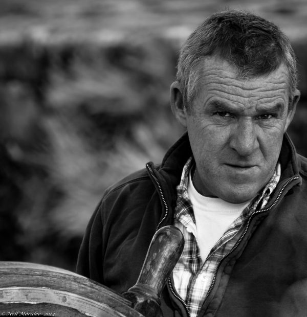 At the wheel of a tall ship.