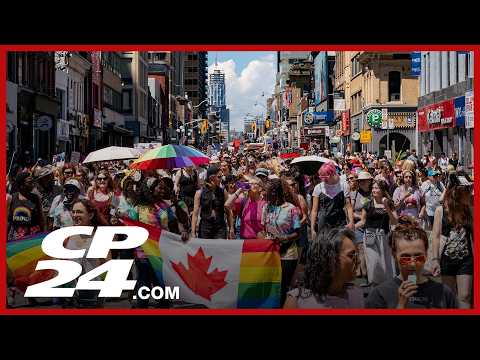 Prime Minister Mark Carney walks in Toronto Pride Parade