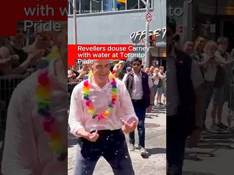 Revellers douse Carney with water at Toronto Pride